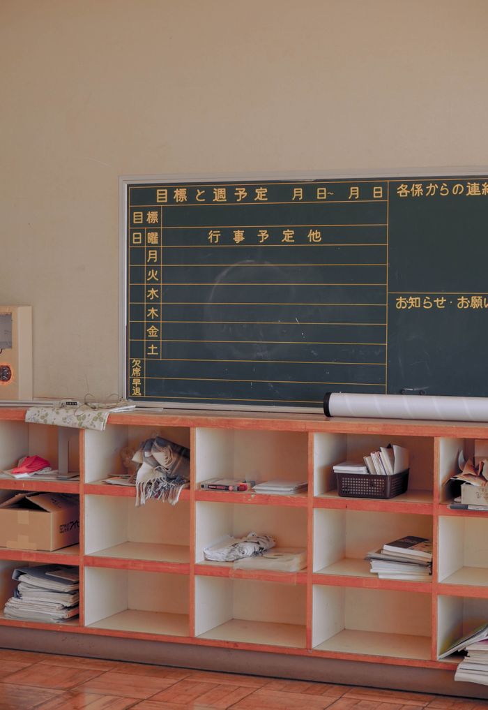 Cozy Japanese classroom interior with a chalkboard and organized wooden shelves, Tochigi, Japan.